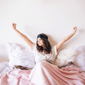 Stop snorning and sleep well. a woman wakes up feeling rested and happy.